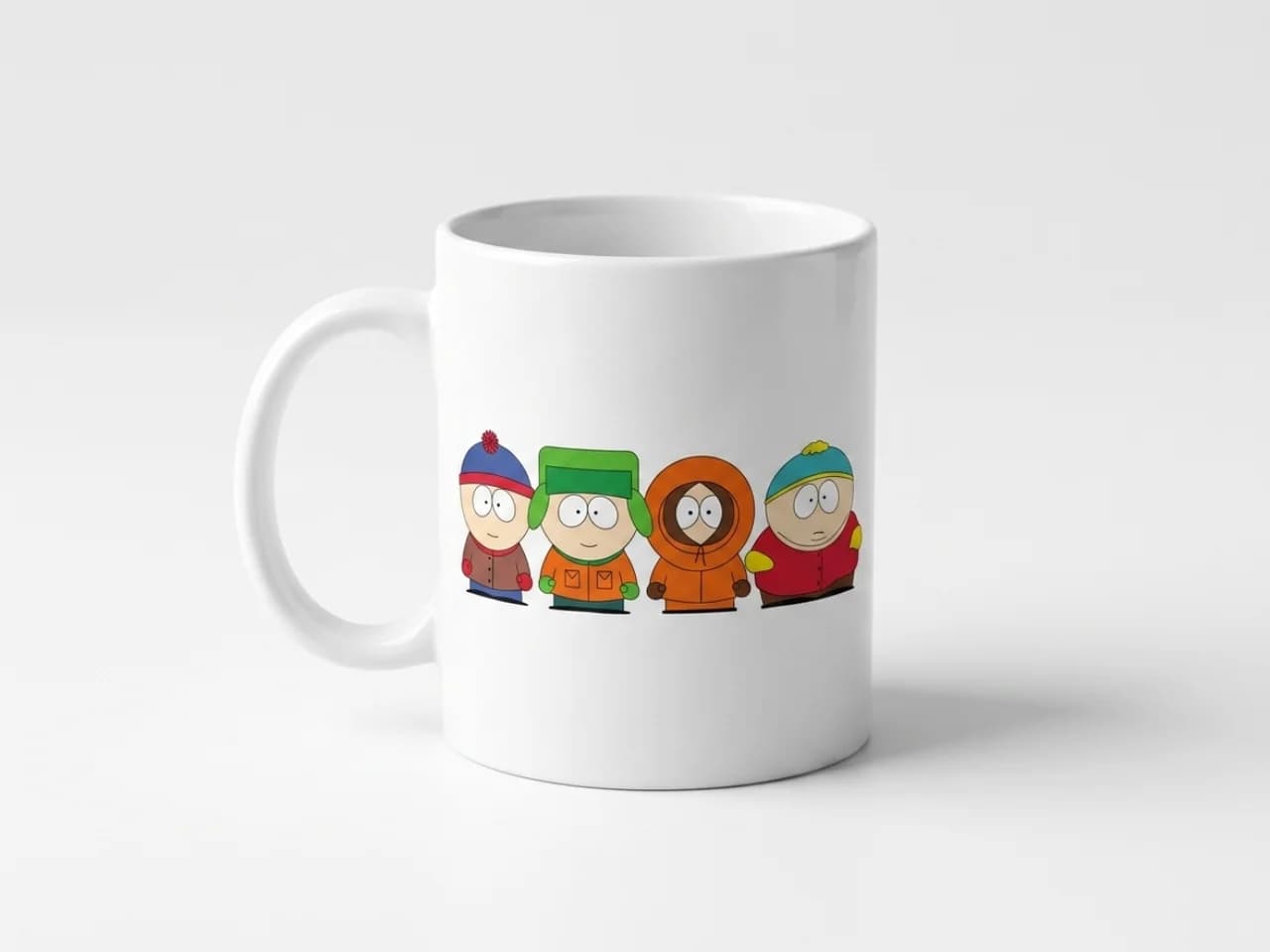 South Park style character graphics shown on a T-shirt, mug, and phone case